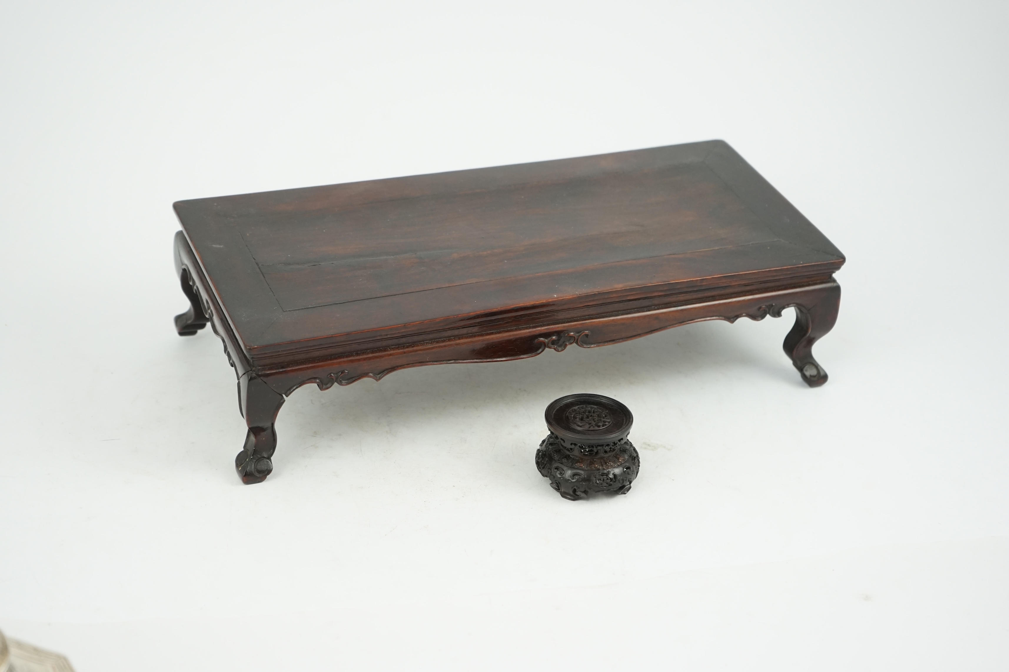 A Chinese huanghuali scholar’s stand, 18th/19th century, and a small reticulated zitan stand, 19th century
